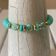 Hand Crafted Teal And Gold Tone Smiley Face Beaded Surfer Bracelet Clearance Price Is Firm Handcrafted By Me With Care And Love So You Can Have A Look All Your Own Created With 6 Mm Heishi Clay Flat Disc Beads And Emoji Smiley Face Beads Size. Best Fits Small And Medium Size Wrists Beach Beachy Casual Colorful Feminine Teen Teens Festival Hawaiian Luau Spring Summer Fall Winter Stretchy Comfortable On Arm Hippy Hippie Solid Color Pastel 60s 70s 90s 80s Y2k Chic New With Tags Stretchy Made In The Smiley Face Beads, Y2k Chic, Hawaiian Bracelets, 80s Y2k, Girly Coquette, Memory Wire Wrap Bracelets, Style Birthday, Bracelets Ideas, Kandi Bracelets