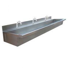 three stainless steel sinks with two faucets on each side