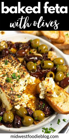 baked feta with olives on a white plate and bread in the background text reads baked feta with olives