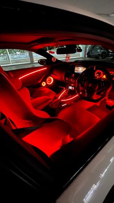 the interior of a car with red lights