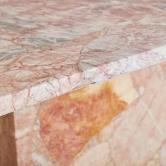 a marble table top that is pink and gold