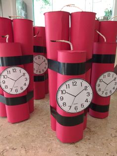 red paper cups with clocks on them sitting on a counter