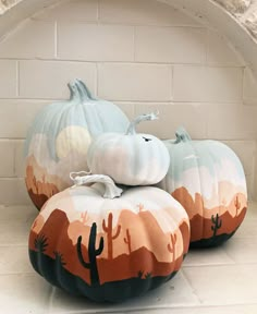 three painted pumpkins sitting on top of each other