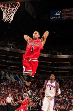 a basketball player jumping up to dunk the ball