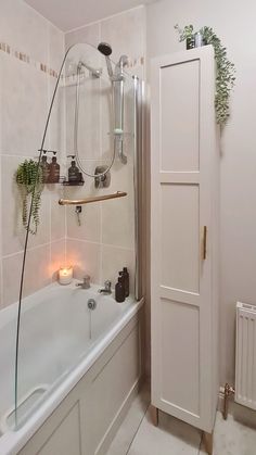 a bath tub sitting next to a white wall