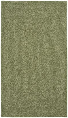 an area rug with green carpeting on the floor and white trimmings around it