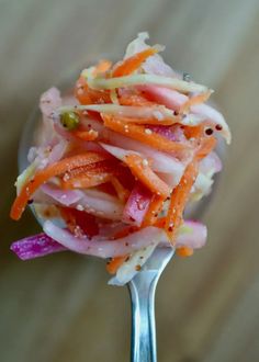 a close up of a fork with food on it