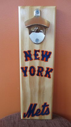 a new york mets bottle opener mounted to a wall