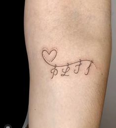 a small tattoo on the leg of a person with words written in cursive writing