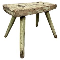 an old wooden bench with nails on the bottom and legs, isolated against a white background