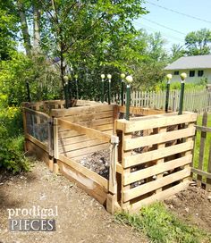 a wooden fenced in area with plants growing out of it