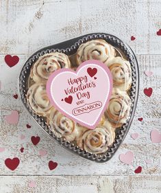 a heart shaped box filled with cinnamon rolls