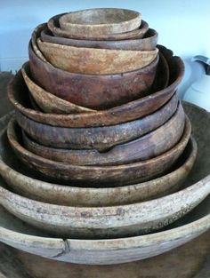 a stack of wooden bowls sitting on top of each other