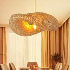 a dining room table with chairs and a chandelier hanging from the ceiling