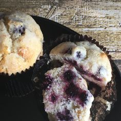 two muffins on a plate with one cut in half