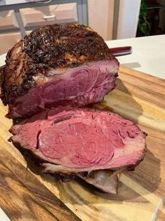 a large piece of meat sitting on top of a wooden cutting board