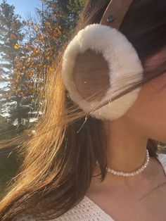 a close up of a person wearing ear muffs