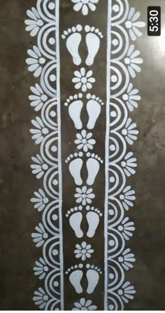 an image of footprints in the middle of a floor with white designs on it and black background