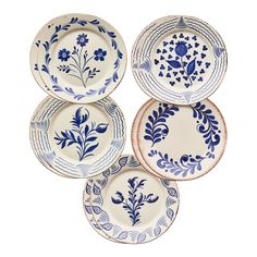 four blue and white plates with floral designs on the rims, all in different shapes and sizes