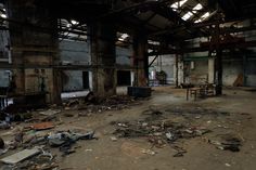 an old warehouse with lots of debris and broken windows