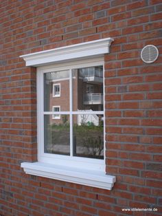 a red brick building with a white window