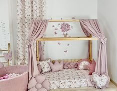 a child's bedroom with pink and white decor