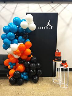 balloons are stacked on top of each other in front of a sign that reads lincoln