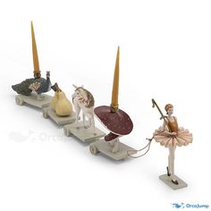 three figurines are lined up in the shape of horses and ballerinas