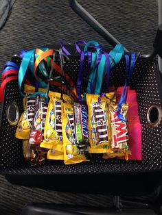 a suitcase filled with candy and ribbons