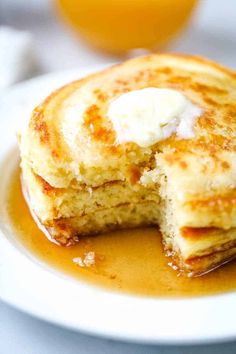 pancakes with butter and syrup on a white plate