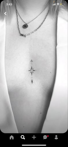 a black and white photo of a woman's chest with a cross on it