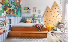 a child's bedroom with colorful decor and artwork