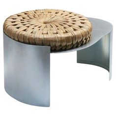 a wicker stool with metal frame and round foot rest on white background, front view