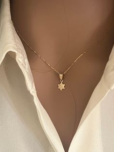 "✨ Embrace spirituality with the 14k Gold Star of David Pendant, a symbol of elegance and cultural significance. This exquisite piece features a delicate 1/2\" Hebrew inscription, meticulously crafted from high-quality 14k gold. The timeless Star of David design radiates sophistication and serves as a meaningful symbol of faith. 🌟 🌟14k Gold Dainty 1.1mm Cable Chain, allowing you to customize your style. Wear this pendant as a connection to heritage, carrying the rich tradition of the Star of David with you. The intricately designed pendant and optional chain make for a versatile accessory suitable for both everyday wear and special occasions. 💖 Product Specification: ------------------------------- * Handmade item * Stamped 14K * Materials: Gold * Pendant height: 12.5 mm / .50\" Inch (I Dainty Star Of David Necklace With Star Charm, Dainty Star Of David Necklace, Gift Delicate Chain Necklace With Star Of David Pendant, Delicate Star Of David Necklace For Gift, Star Of David Gold Necklace, Cutest Jewelry, David Ring, Jewish Necklace, Jewish Star