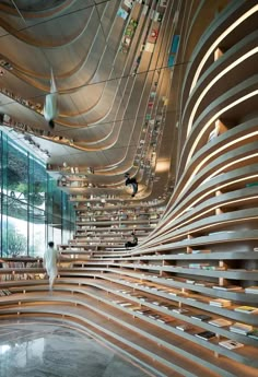 the inside of a building with wooden slats and birds flying around in the air