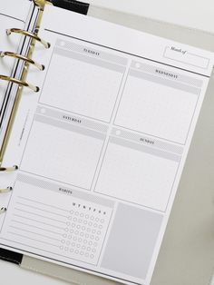 an open planner book on top of a desk