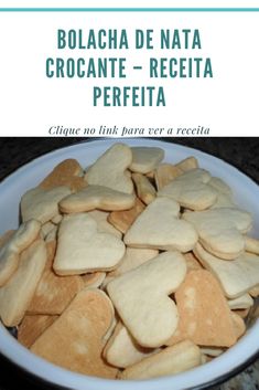 a white bowl filled with cut up heart shaped cookies