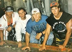 four young men are posing for a photo