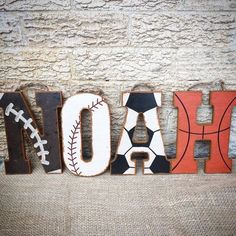 the word hola spelled in wood letters with baseballs and basketballs on it