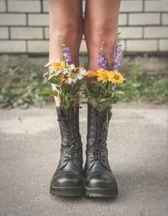 a pair of boots with flowers in them