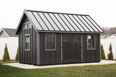 a small gray shed with a metal roof