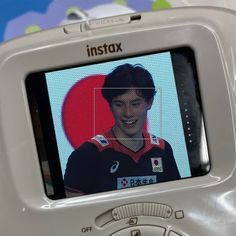 a close up of a person's face on a cell phone with an instax screen