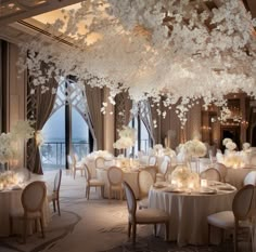 the tables are set with white flowers and candles