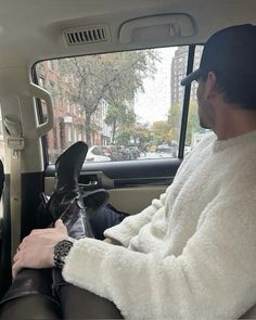 a man sitting in the back seat of a car