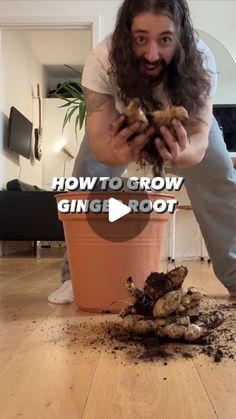 a man with long hair and beard standing in front of a flower pot filled with dirt