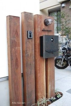 a motorcycle is parked next to two wooden posts on the side of the street,