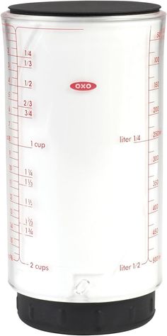 a white blender with measurements on the front and side sides for measuring food in it