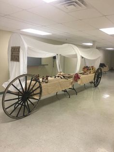 an old fashioned wagon is set up in the middle of a room