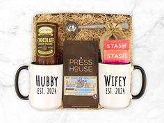 the coffee gift box includes two mugs, an espresso and some chocolate