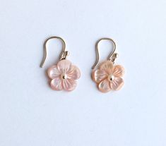 "These earrings are from our Flower Collection. Each piece in this collection features one or more hand-carved genuine stone flowers. Hand-sculpted from pink Mother of Pearl into beautiful floral blooms, the flowers measure 15mm and have white Fresh Water Pearls at their centers.  Earring Length: 1.13\" Closure: S Hook" Pink Flower Shaped Pierced Earrings, Elegant Pink Jewelry With 3d Flowers, Delicate Pink Pierced Earrings, Mother Of Pearl Flower Earrings As Gift, Feminine Flower Jewelry With 3d Flowers, Feminine 3d Flower Jewelry, Pink Round Earrings With Flower Charm, Feminine Flower-shaped Jewelry With Matching Earrings, Pink Birth Flower Earrings For Wedding